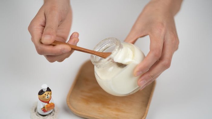 Probiotic foods including yogurt, kimchi, and kefir arranged on a wooden surface for gut health